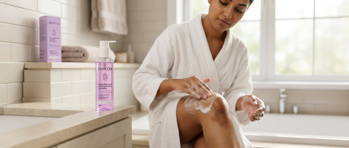  Indian woman applying niacinamide body lotion to dark elbow — brightening routine for body pigmentation