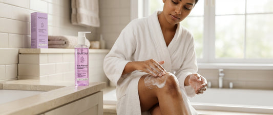  Indian woman applying niacinamide body lotion to dark elbow — brightening routine for body pigmentation