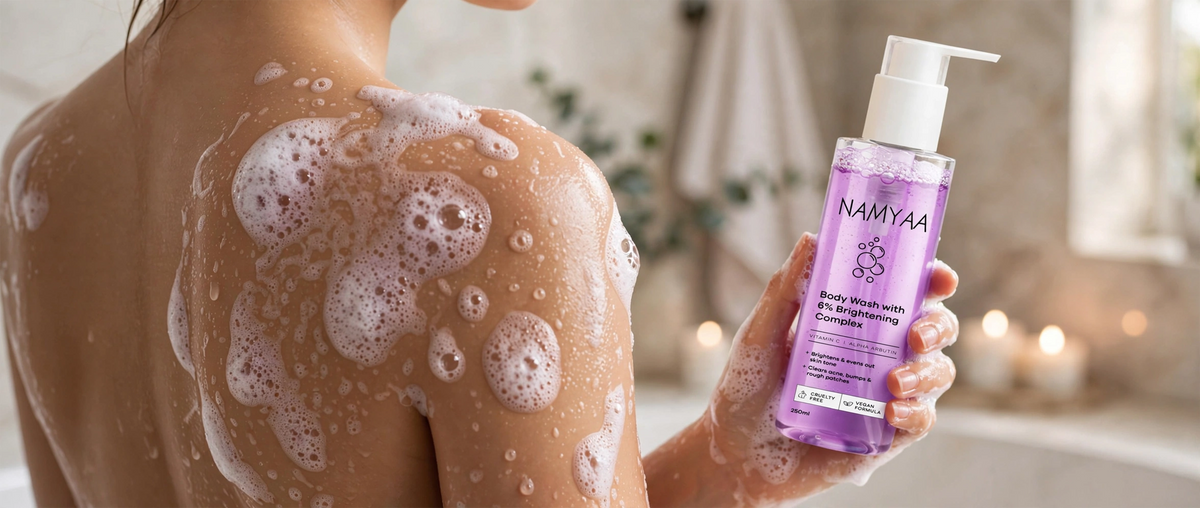 Namyaa Body Wash with 6 percent Brightening Complex, Vitamin C, and Alpha Arbutin held in hand during shower