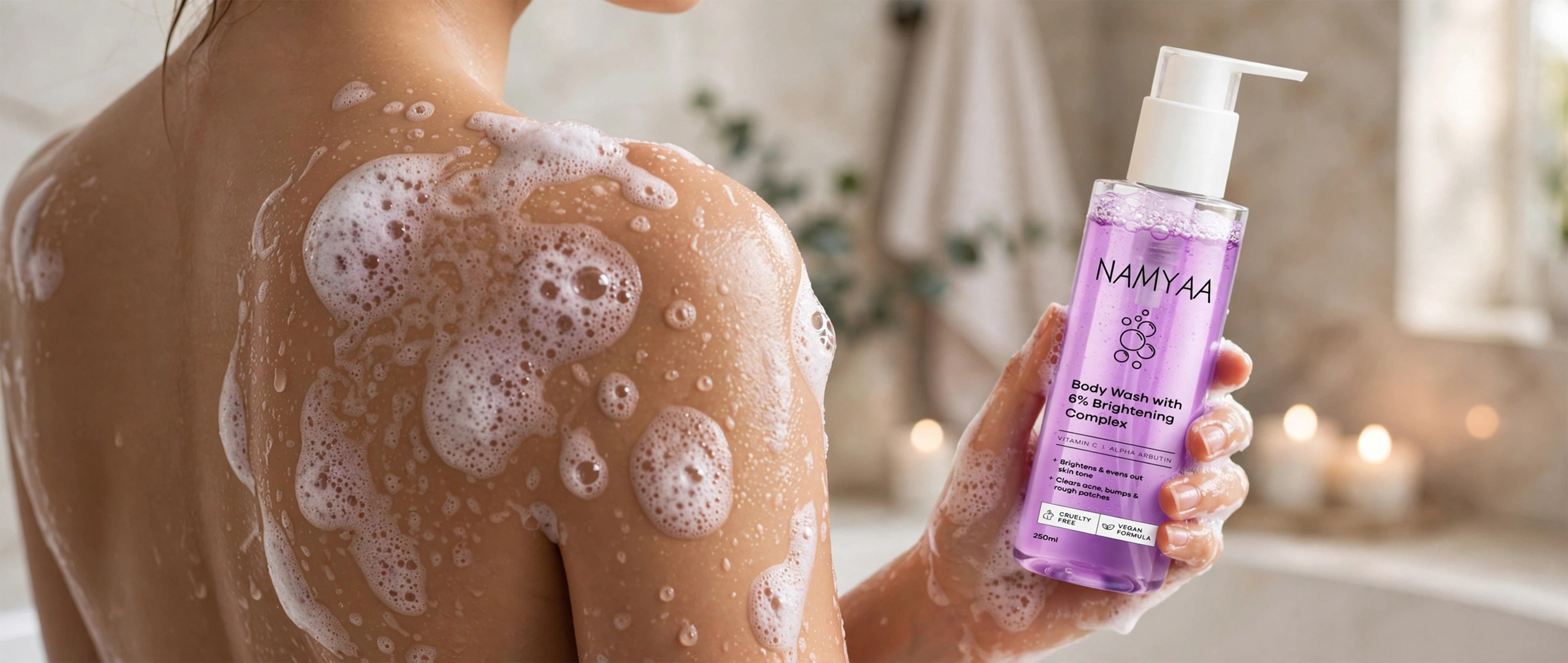 Namyaa Body Wash with 6 percent Brightening Complex, Vitamin C, and Alpha Arbutin held in hand during shower