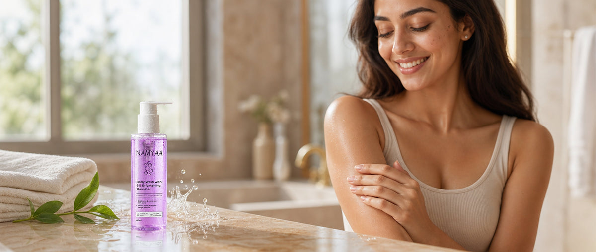 Namyaa brightening body wash bottle on a bathroom shelf with soft natural lighting