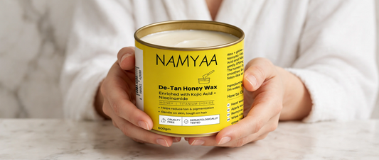 Woman holding a 600gm tin of Namyaa De-Tan Honey Wax for hair removal, tan reduction, and pigmentation control