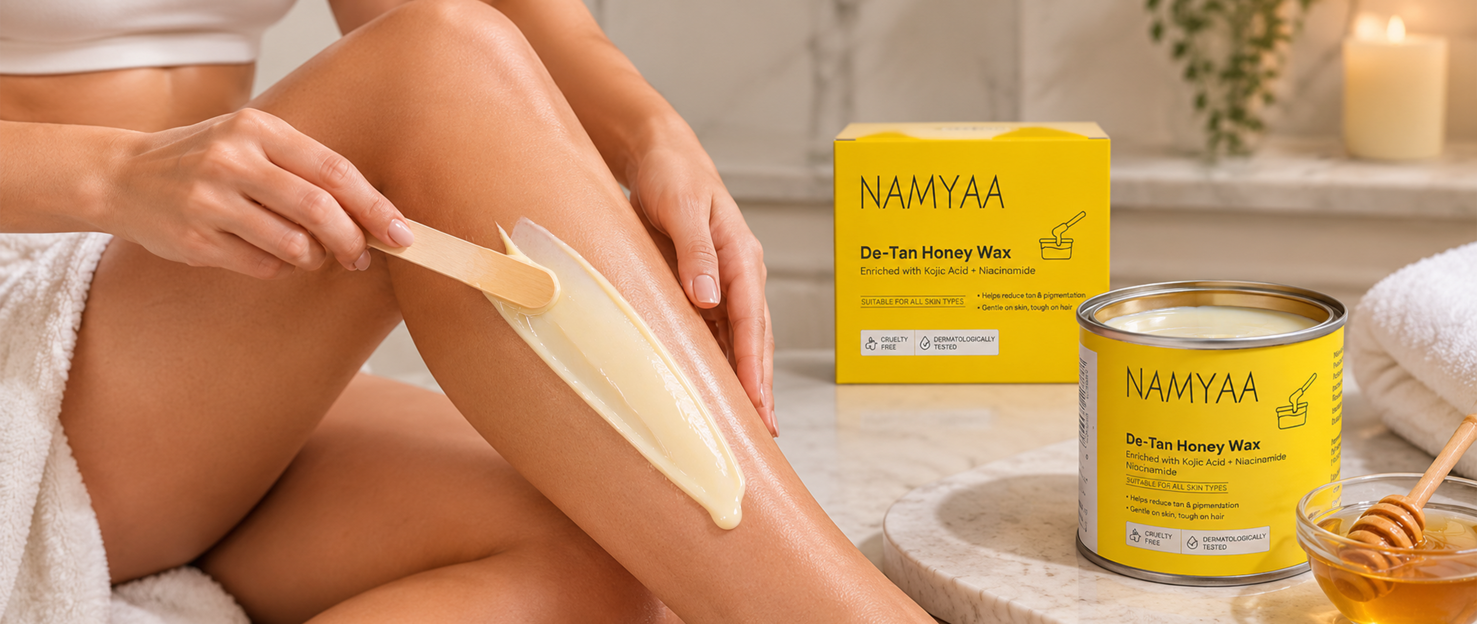 Namyaa De-Tan Honey Wax with Kojic Acid and Niacinamide applied on leg with wooden spatula