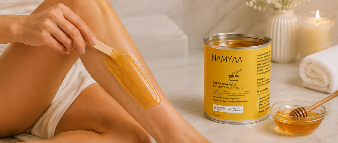 Namyaa Gold Honey Wax enriched with Pilisoft applied on leg with wooden spatula