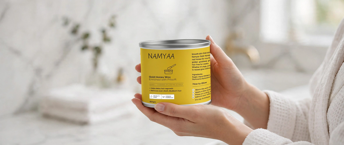 Woman in bathrobe holding a 600gm tin of Namyaa Gold Honey Wax enriched with Pilisoft to delay hair regrowth