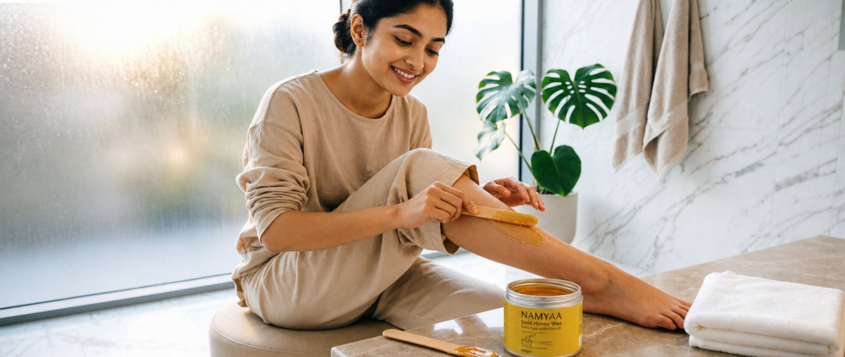 Woman applying Namyaa gold honey hair removal wax for smooth legs during a self-care routine.