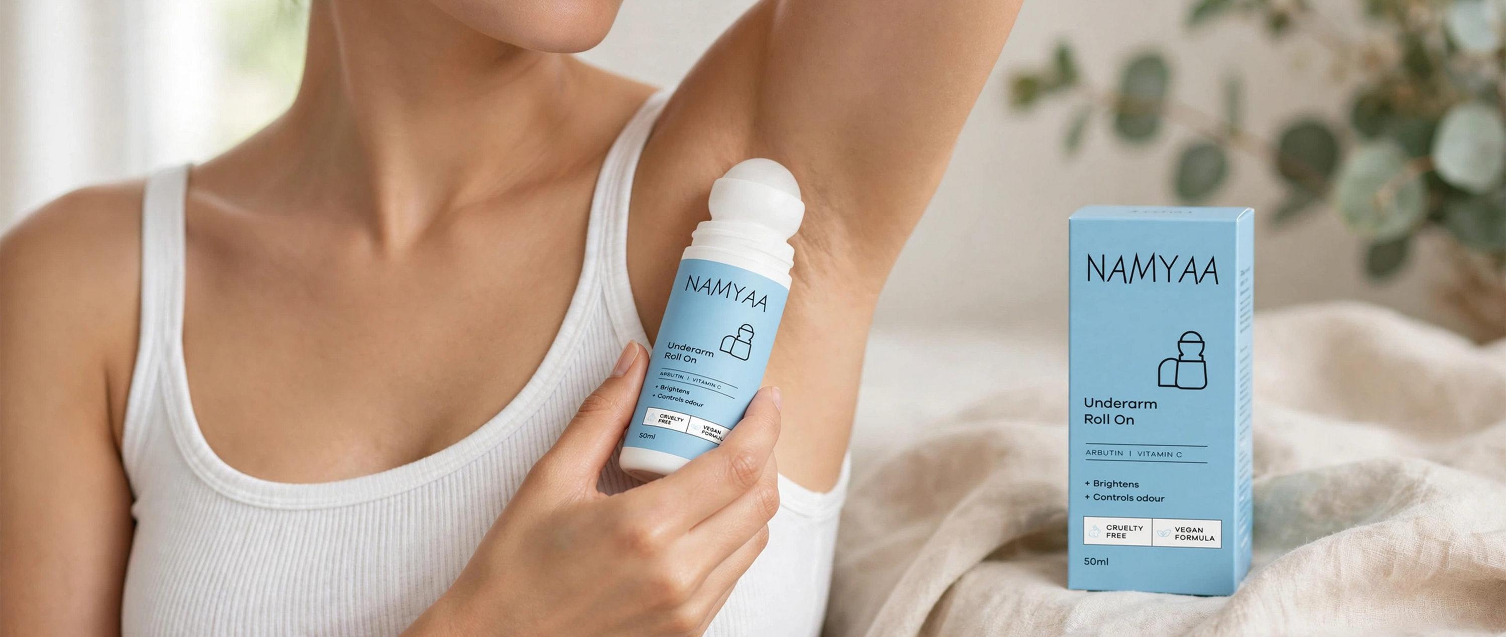 Namyaa Underarm Roll On with Arbutin and Vitamin C applied on underarm with product box