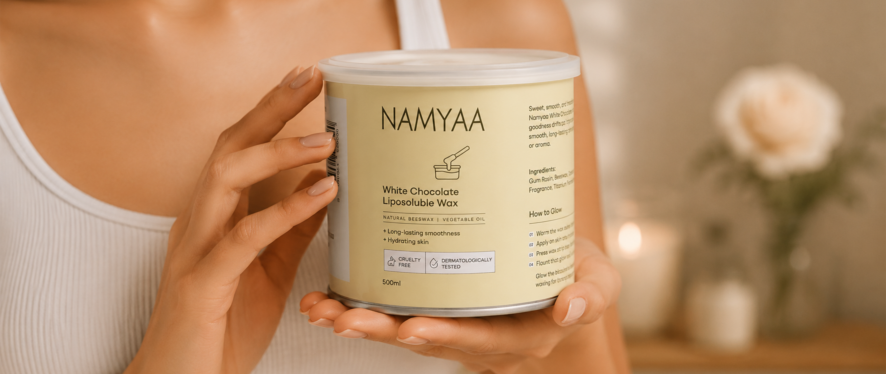 Woman holding Namyaa White Chocolate Liposoluble Wax with natural beeswax for hydrating skin and long-lasting smoothness