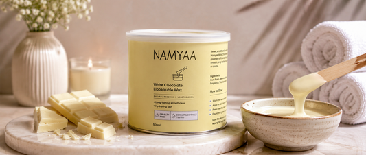 500ml Namyaa White Chocolate Liposoluble Wax tin displayed with creamy wax and wooden spatula for long lasting smoothness